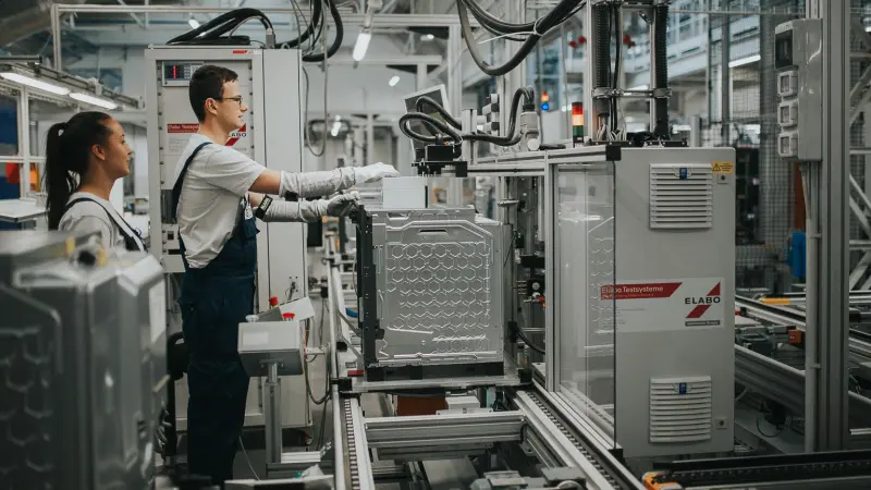 Employees next to the production line