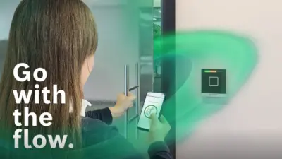 Woman getting authorization to enter a door by using mobile access.