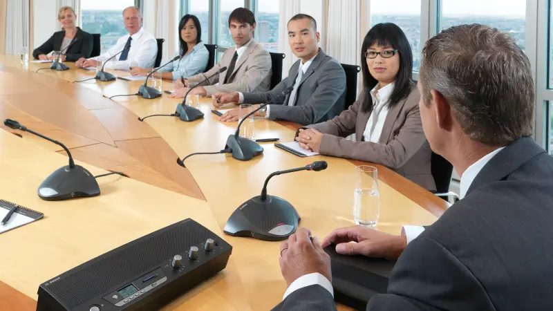 A chairman using the CCS 900 Ultro Discussion system at a meeting