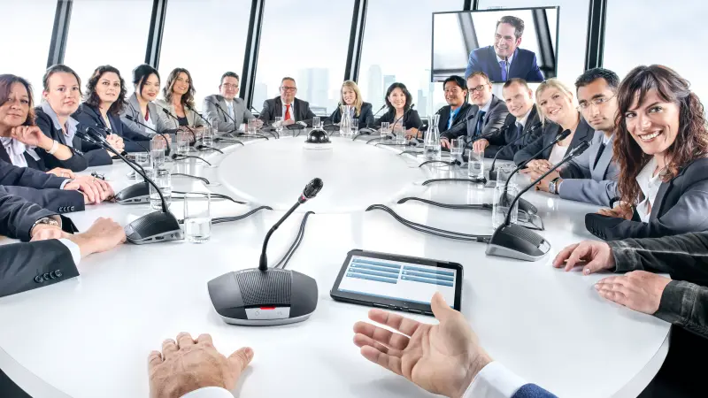 A chairman using a CCS 1000 D chairman device at a meeting